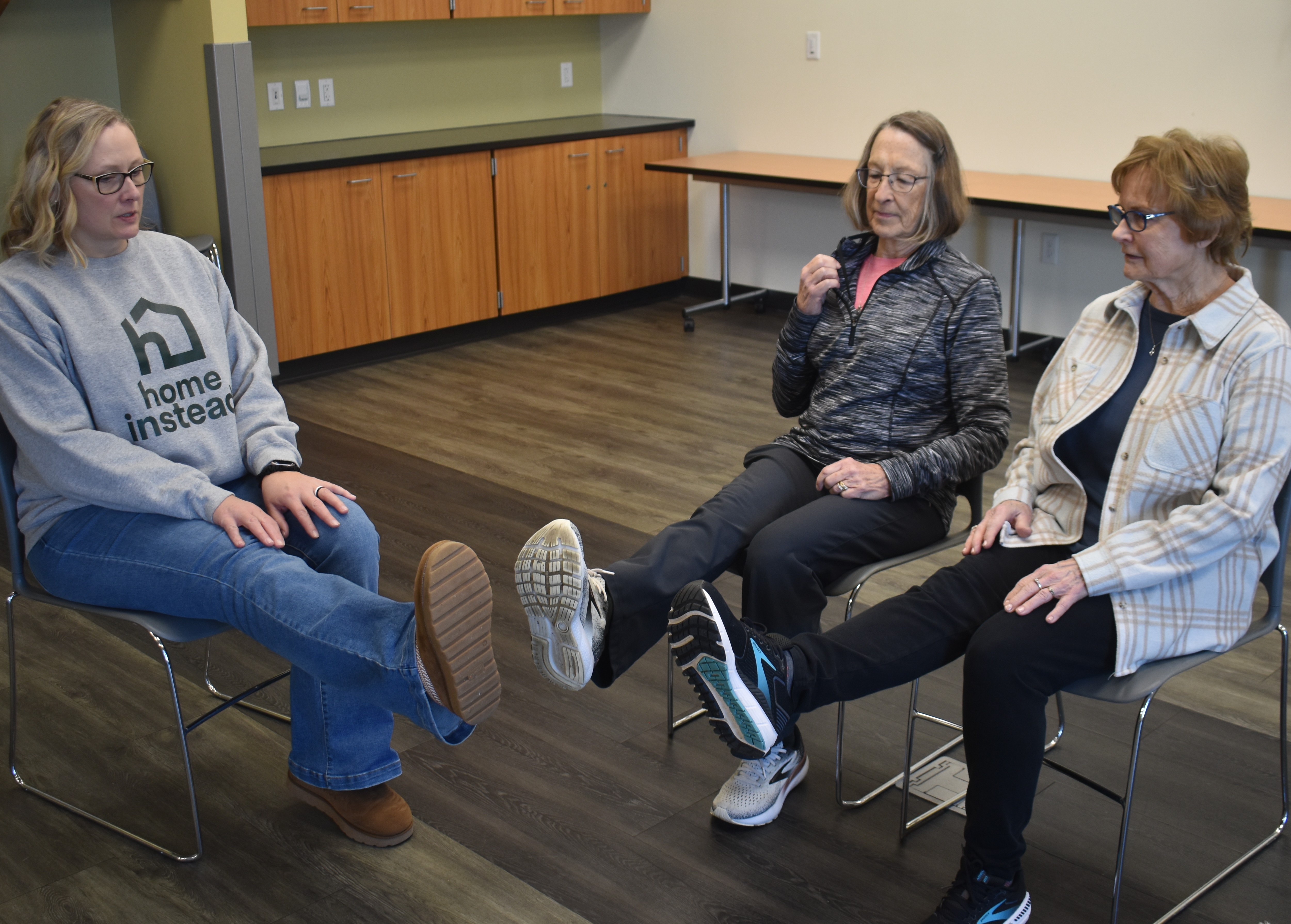 Dannette Huber from Home Instead (left), one of the instructors for the Stepping On program, works with attendees Lesley Phillips and Carole Bjerke on exercises during the booster class on Jan. 26 for Stepping On members who took the fall 2025 session. Exercises focus on improving balance and building leg muscle strength and are quick and easy to do from home.